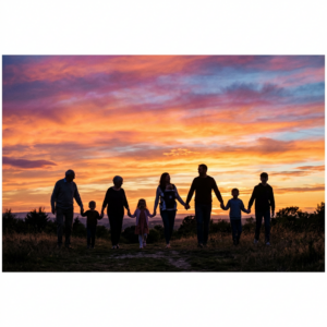 Family of eight walking hand in hand outdoors at sunset with vivid sky